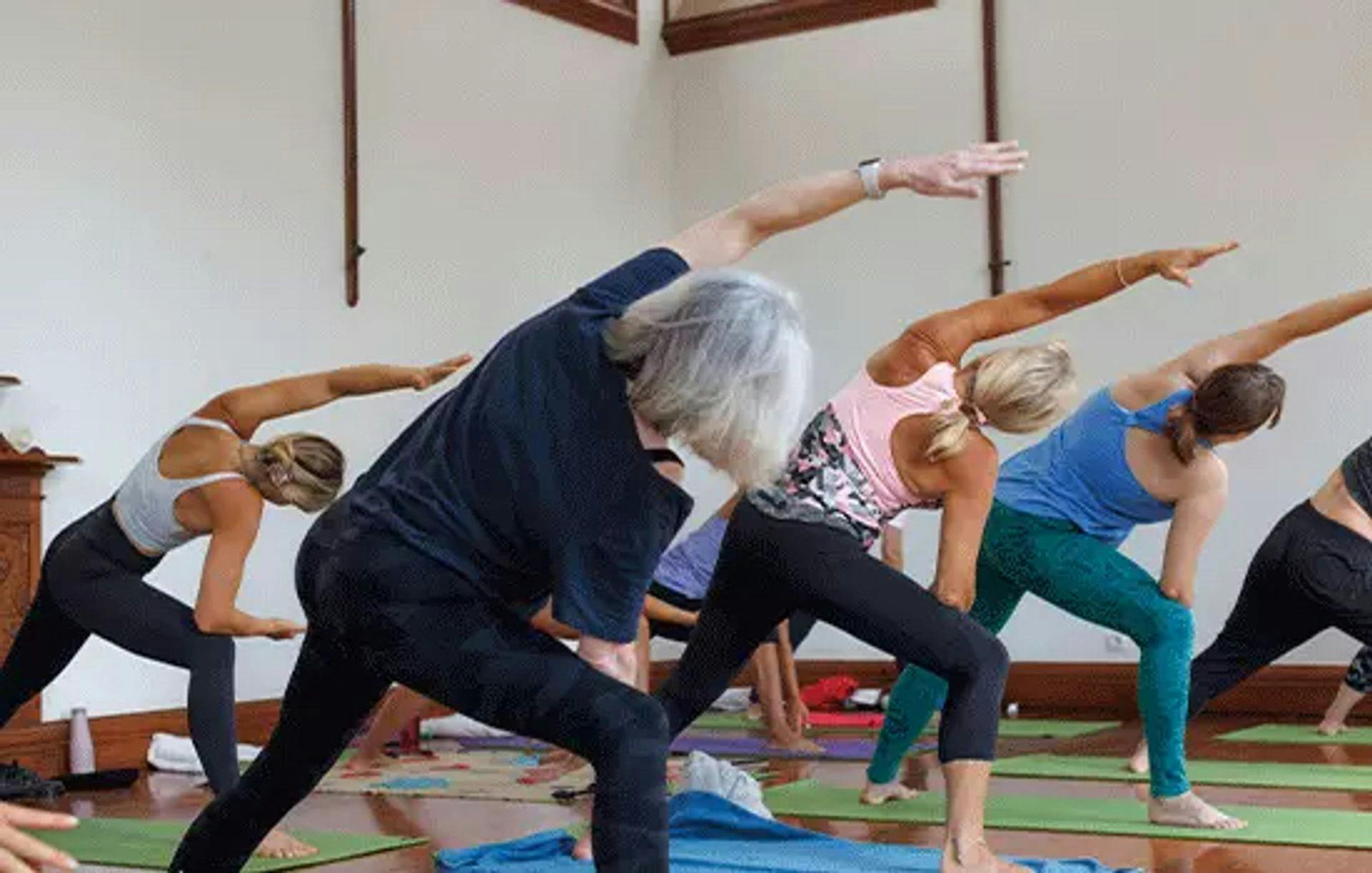 yoga teacher stretching